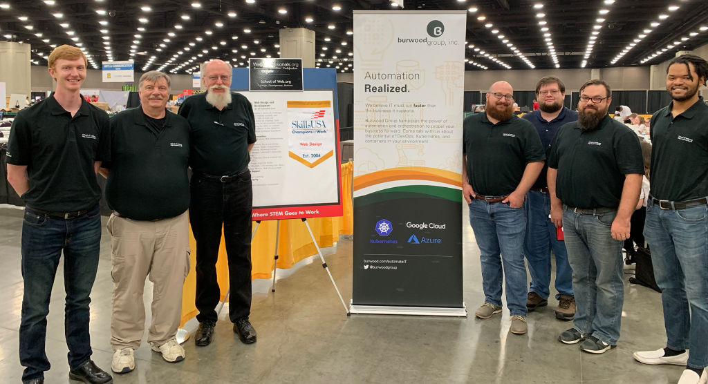 Our onsite team of Web Professionals who make certain the competition runs smoothly. All are standing in front of our contest banner and promotional banners.