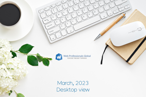 Desktop with a keyboard, mouse, notepad, pencil, flowers