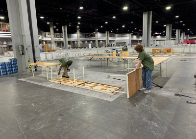 Members of Courtesy Corps setting up tables